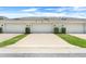 A row of two-car garages with manicured landscaping and decorative outdoor lighting at 15540 Blackbead St, Winter Garden, FL 34787