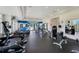 Well-equipped fitness center featuring modern exercise machines, weights, and a mirrored wall at 15540 Blackbead St, Winter Garden, FL 34787