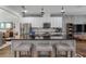 Kitchen island with seating, stainless appliances and modern pendant lighting at 15540 Blackbead St, Winter Garden, FL 34787