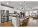 Spacious kitchen island and stainless appliances with sightlines into the living area at 15540 Blackbead St, Winter Garden, FL 34787