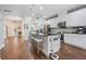 Open concept kitchen island with bar stool seating, stainless appliances, and crisp white cabinetry at 15540 Blackbead St, Winter Garden, FL 34787