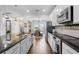 Bright, modern kitchen featuring stainless steel appliances, granite countertops and an island at 15540 Blackbead St, Winter Garden, FL 34787