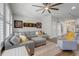 Comfortable living room showcasing stylish decor, an oversized sofa, and shuttered windows at 15540 Blackbead St, Winter Garden, FL 34787