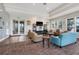 Inviting residents' lounge with comfortable seating, contemporary decor, and ample natural light at 15540 Blackbead St, Winter Garden, FL 34787