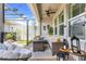 Relaxing patio area with comfortable seating, overhead pergola, ceiling fan, and string lights at 15540 Blackbead St, Winter Garden, FL 34787