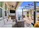 Inviting outdoor patio area featuring comfortable seating, a grill, and a charming pergola at 15540 Blackbead St, Winter Garden, FL 34787