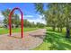 Community playground area with play equipment and wood chip groundcover and surrounding lawns at 15540 Blackbead St, Winter Garden, FL 34787