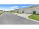 Charming townhomes with manicured landscaping and private two-car garages under a bright blue sky at 15540 Blackbead St, Winter Garden, FL 34787
