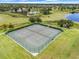 Aerial view of the community's tennis courts, surrounded by well-maintained landscaping and with benches for players to rest at 15540 Blackbead St, Winter Garden, FL 34787
