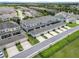 Aerial view showcases attached townhomes with garages, driveways, backyard patios, and neatly manicured landscaping at 15540 Blackbead St, Winter Garden, FL 34787
