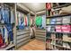 Organized walk-in closet with shelving for clothing, shoes, and accessories at 15540 Blackbead St, Winter Garden, FL 34787