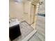 Bathroom featuring a dark vanity with a marble countertop and a built-in shower at 1720 Foxhall Cir # 1720, Kissimmee, FL 34741