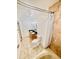 Bathroom with tiled walls, shower, tub, dual sinks and toilet, with warm lighting at 1720 Foxhall Cir # 1720, Kissimmee, FL 34741