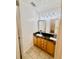 Bathroom featuring tile floors, dual sinks, a mirror, and warm lighting at 1720 Foxhall Cir # 1720, Kissimmee, FL 34741
