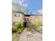 Brick building with dark trim, black staircase, green bushes, and sidewalk leading up to it at 1720 Foxhall Cir # 1720, Kissimmee, FL 34741