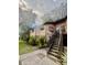 Brick building with dark trim and black staircase, surrounded by trees and grass at 1720 Foxhall Cir # 1720, Kissimmee, FL 34741