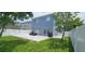 Landscaped backyard with white fence, patio seating, and well-maintained lawn at 1827 Meadow Pond Way, Orlando, FL 32824