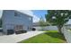 Large patio with seating, surrounded by a grassy area, leading to a fenced property line at 1827 Meadow Pond Way, Orlando, FL 32824
