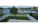 Fenced backyard with grass, patio, and a serene pond view beyond at 1827 Meadow Pond Way, Orlando, FL 32824