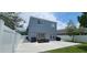 Spacious backyard patio with outdoor seating, grill, and view of the two story house at 1827 Meadow Pond Way, Orlando, FL 32824