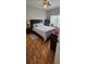 Bedroom featuring wood-look floors and dark wood bedroom set at 1827 Meadow Pond Way, Orlando, FL 32824