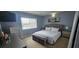 Bedroom with a double bed, window and two bedside tables with lamps at 1827 Meadow Pond Way, Orlando, FL 32824