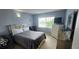 Inviting bedroom featuring a comfortable bed and natural light from the window at 1827 Meadow Pond Way, Orlando, FL 32824