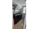 Functional laundry room with modern black washer and dryer units at 1827 Meadow Pond Way, Orlando, FL 32824