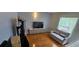Cozy living room with modern sofa, wood floor, and a large window for natural light at 1827 Meadow Pond Way, Orlando, FL 32824