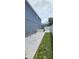 Exterior shot showing the side yard of the house with a concrete patio and fence at 1827 Meadow Pond Way, Orlando, FL 32824