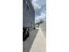 Showing a side yard with a long concrete path and some trash bins near the fence at 1827 Meadow Pond Way, Orlando, FL 32824