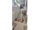 Well-lit staircase with white railings and wood steps at 1827 Meadow Pond Way, Orlando, FL 32824