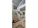 Staircase featuring decorative tile flooring, white railings and wood stairs at 1827 Meadow Pond Way, Orlando, FL 32824