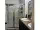 Modern bathroom featuring a glass-enclosed shower and dual sink vanity with granite countertop at 1868 Katz Crossing Dr, Kissimmee, FL 34744