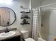 Bathroom features a vanity, toilet and shower with decorative shelves and neutral color palette at 1868 Katz Crossing Dr, Kissimmee, FL 34744