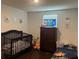 This is a bedroom with a crib, dresser and toys at 1868 Katz Crossing Dr, Kissimmee, FL 34744