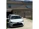 Home exterior features a modern car in the driveway, garage, and solar panels at 1868 Katz Crossing Dr, Kissimmee, FL 34744