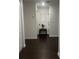 Hallway with dark floors, white trim and a decorative table at 1868 Katz Crossing Dr, Kissimmee, FL 34744