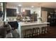 Modern kitchen featuring dark cabinets, stainless steel appliances, and a center island at 1868 Katz Crossing Dr, Kissimmee, FL 34744