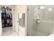 Bathroom detail of a glass-enclosed shower with tiled walls and an adjacent walk-in closet at 1875 Spring Shower Cir, Kissimmee, FL 34744