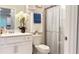 Bathroom showcasing a vanity with floral accents, a toilet and a glass enclosed shower at 1875 Spring Shower Cir, Kissimmee, FL 34744