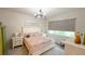 Bright bedroom featuring a decorative chandelier and white furniture set, creating a calming space at 1875 Spring Shower Cir, Kissimmee, FL 34744