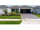 Exterior view of the home with garage featuring landscaped yard and brick paver driveway at 1875 Spring Shower Cir, Kissimmee, FL 34744