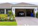 View into the two-car garage, highlighting the interior space and access from the driveway, including an electric car at 1875 Spring Shower Cir, Kissimmee, FL 34744