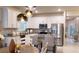 Bright kitchen with island, stainless appliances, and pendant lighting seamlessly blends with the dining area at 1875 Spring Shower Cir, Kissimmee, FL 34744