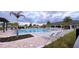 Resort-style community pool with lounge chairs, palm trees, and a clubhouse for ultimate relaxation and recreation at 1875 Spring Shower Cir, Kissimmee, FL 34744