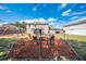 Backyard with a fire pit, chairs, and a gazebo, perfect for entertaining guests and enjoying outdoor living at 1912 Maury Rd, St Cloud, FL 34771