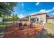 Backyard with a fire pit, chairs, gazebo, picnic table, and grill, perfect for outdoor cooking and entertaining at 1912 Maury Rd, St Cloud, FL 34771