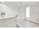 Modern bathroom features white vanity, soaking tub, and ample natural light at 1912 Maury Rd, St Cloud, FL 34771