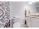 Bathroom featuring a granite countertop, black and white shower curtain, and a toilet at 1912 Maury Rd, St Cloud, FL 34771